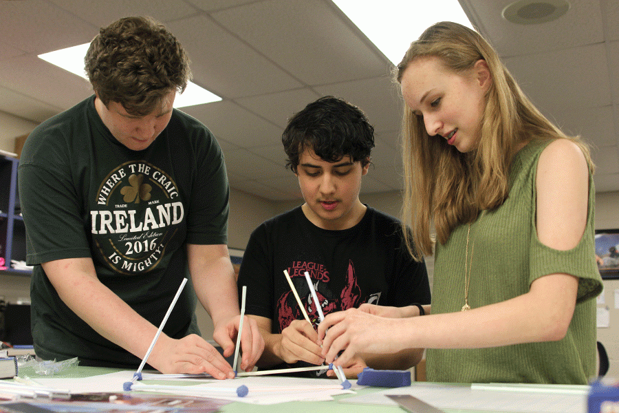 Sophomore Elizabeth Fraka works with her partners to put their dome idea into practice. 