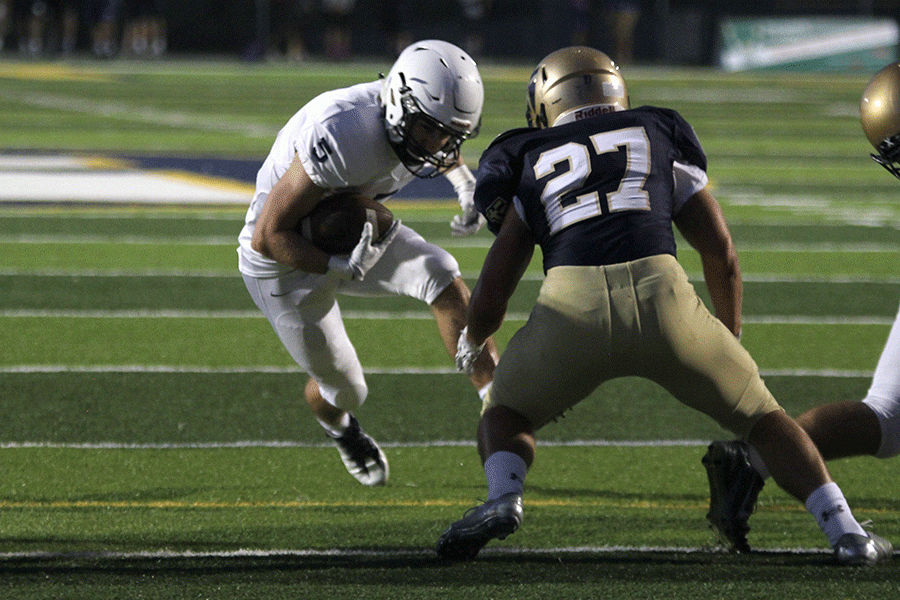 Attempting to score a touchdown, sophomore Logan Talley tries to fake out his defender. 