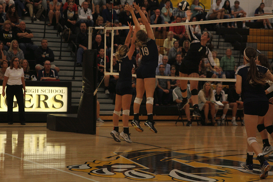 Senior Emma Mantel and sophomore Adelle Warford go up for a block against Blue Valleys right side hitter.