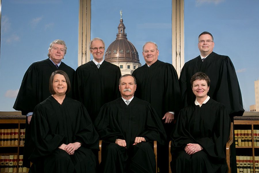 Seated, from left to right, are justices Marla Luckert, Lawton Nuss and Carol Beier, while justices Daniel Biles, Eric Rosen, Lee Johnson and Caleb Stegall stand behind them.