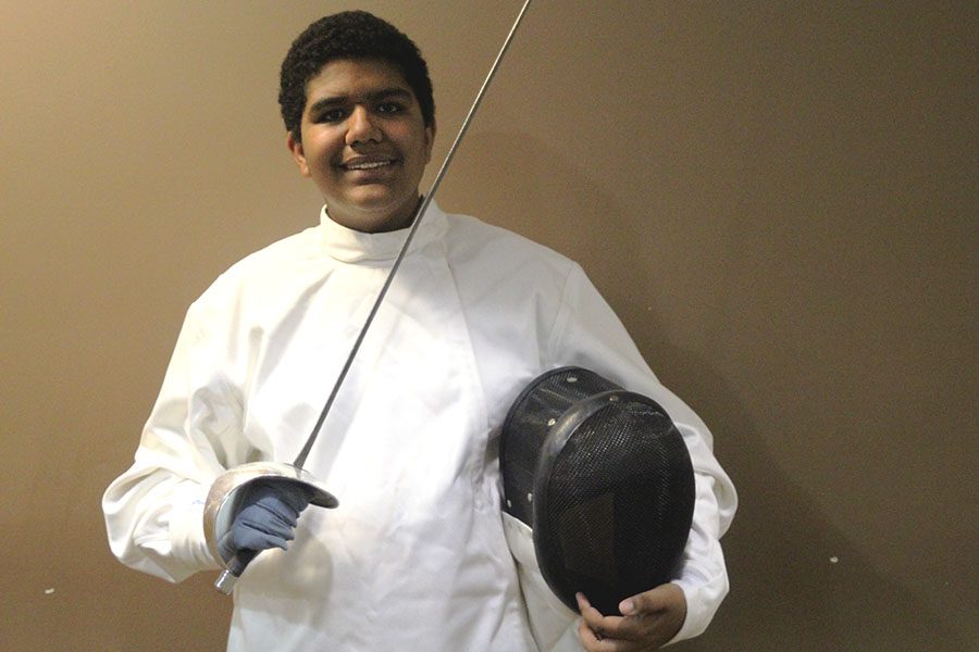 Dressed in his fencing gear, freshman Jadon Taylor stands with his Saber and mask on Saturday, Oct. 23. I get really excited [during a match], Taylor said. Of course you have to remain kind and sportsmanlike to your friends and whoever you beat, but in my mind Im taunting them.