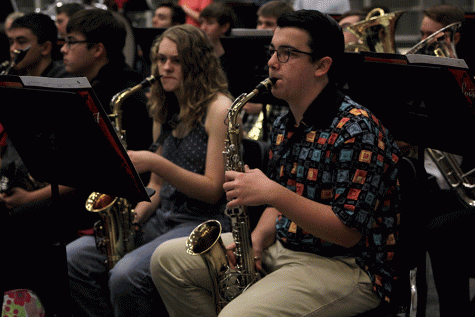 Senior Collin Petigna plays his saxophone in preparation for the Tuesday, Dec. 13 band concert.