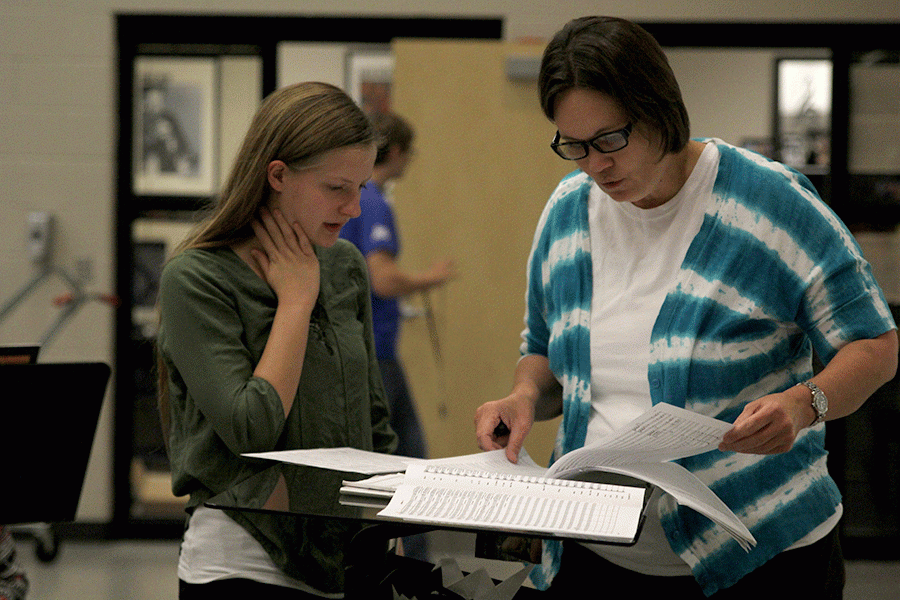 Band director Deb Steiner helps sophomore Jordyn Allen during a break in class on Tuesday, Nov. 8. With the quickly approaching winter concert, focus is beginning to shift away from football performances.