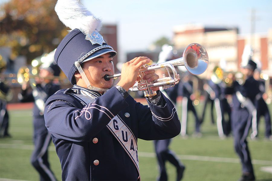 Senior Parker Billing preforms his solo during the band halftime show.