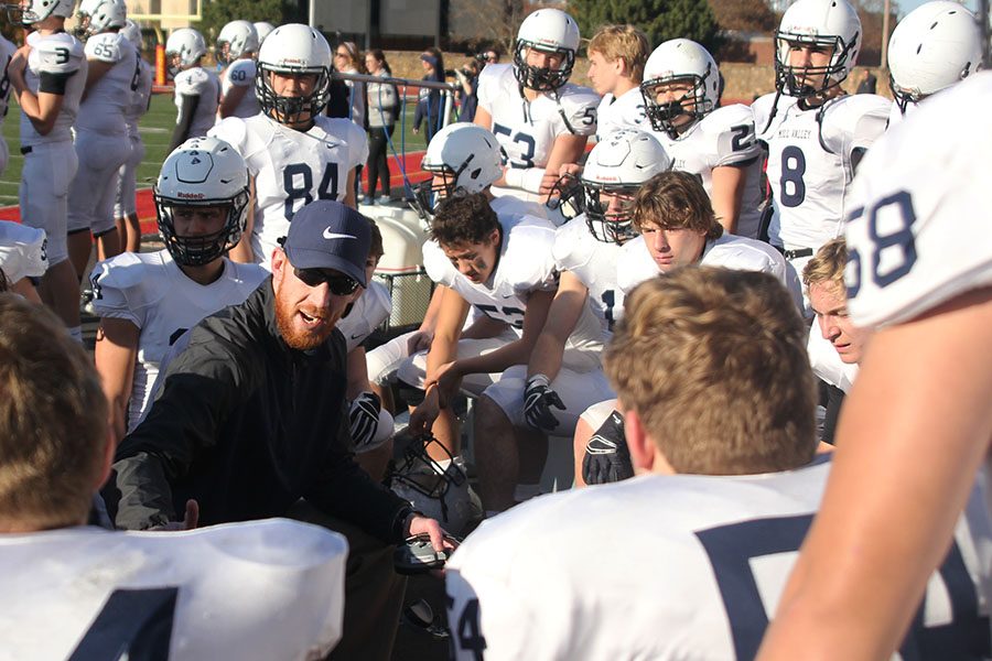 Defensive coordinator Drew Hudgins speaks to the defensive players during overtime.
