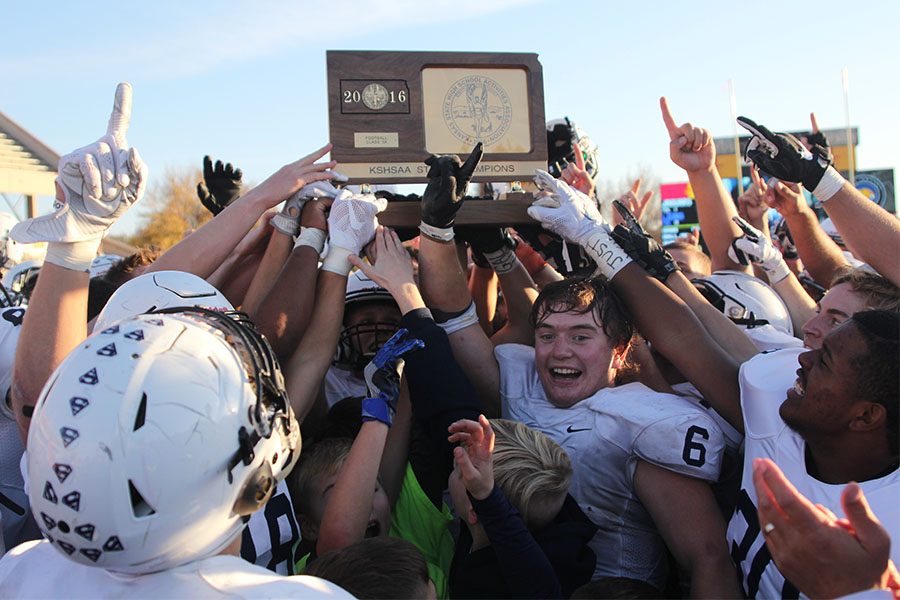 The team holds up the state championship trophy on Saturday, Nov. 26.
