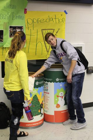 Junior Trent Anderson places coat in the bin on Monday, Nov. 7