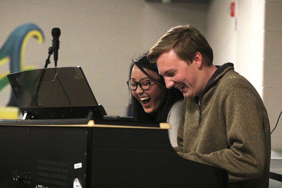 During Open Mic Night on Monday, Nov. 28, seniors Sue Kim and Brady Rolig play the piano together while laughing.