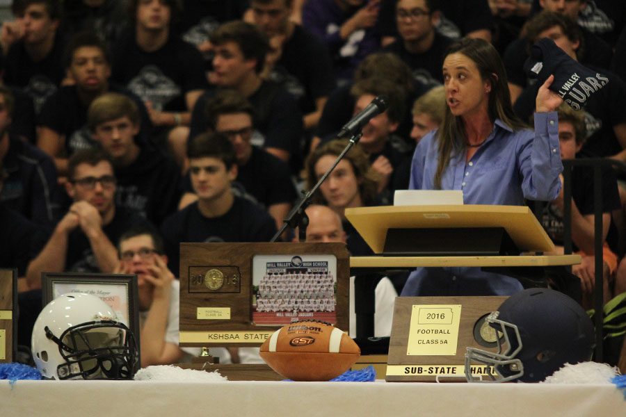 Shawnee Mayor Michelle Distler waves spirit wear through the air as she proclaims Mill Valley High School Jaguars day.