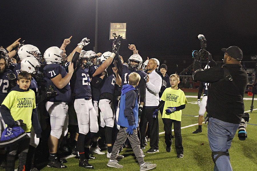 After the game, the jaguars hold up the sectional championship plaque on Friday, Nov. 11.