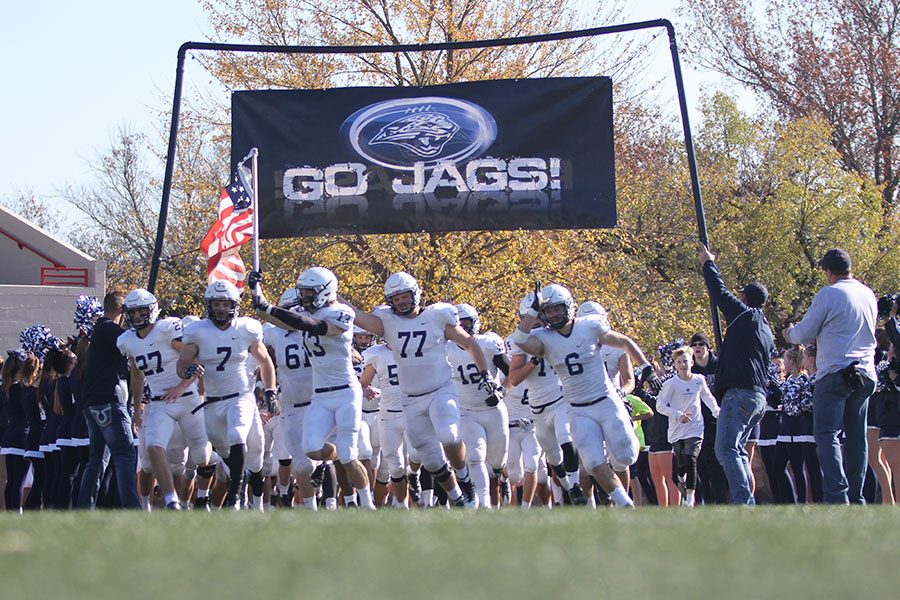 Before the start of the game, senior Joel Donn leads the team on to the field.