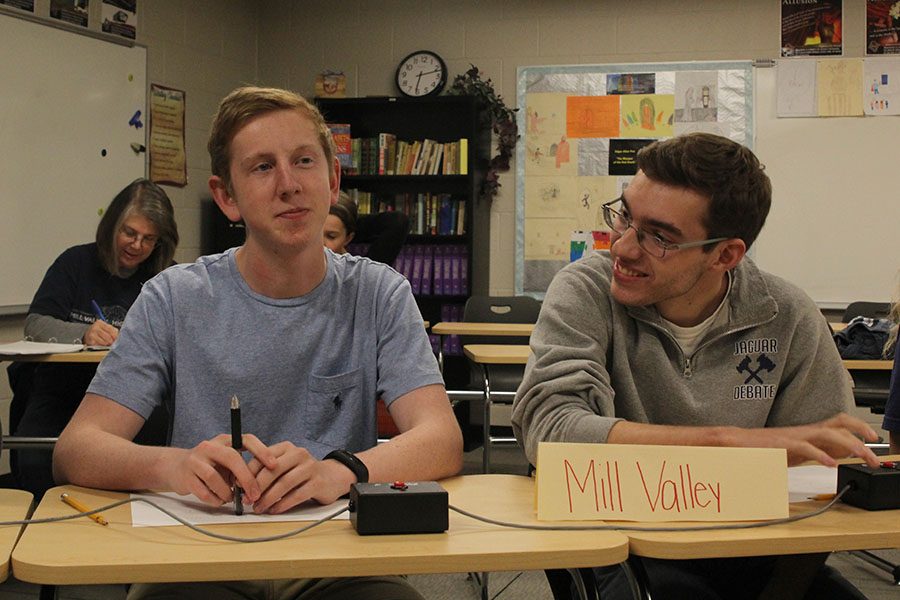 Smiling at a ridiculous answer, senior Tom McClain takes a break from the high-stress round while junior Landon Butler stays focused.
