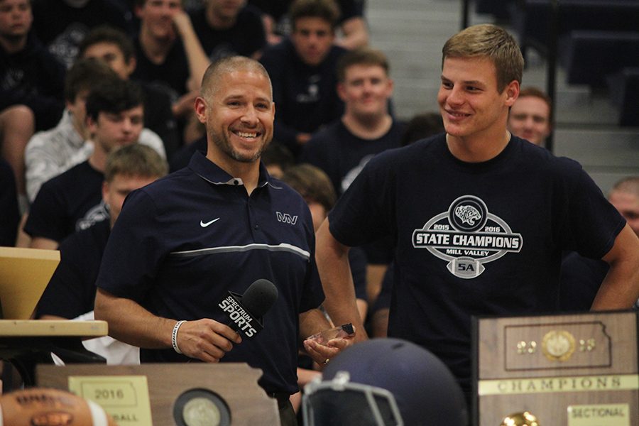 At the pep assembly on Tuesday, Nov. 29, head football coach Joel Applebee helps award junior Brody Flaming as Student Athlete of the Week.