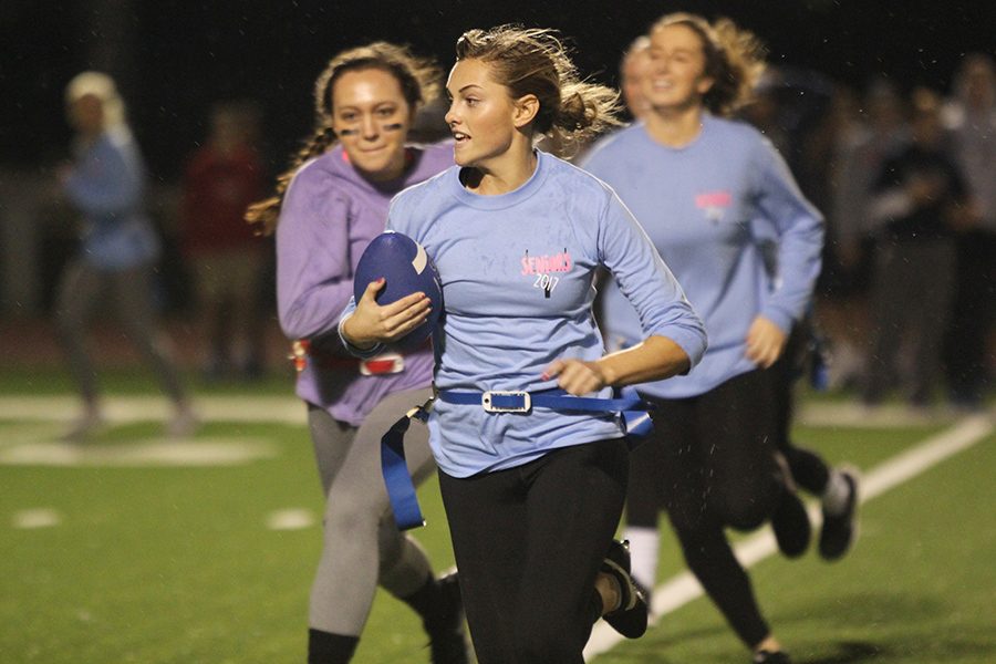 Senior Sydney Hookstra runs the ball down the field.