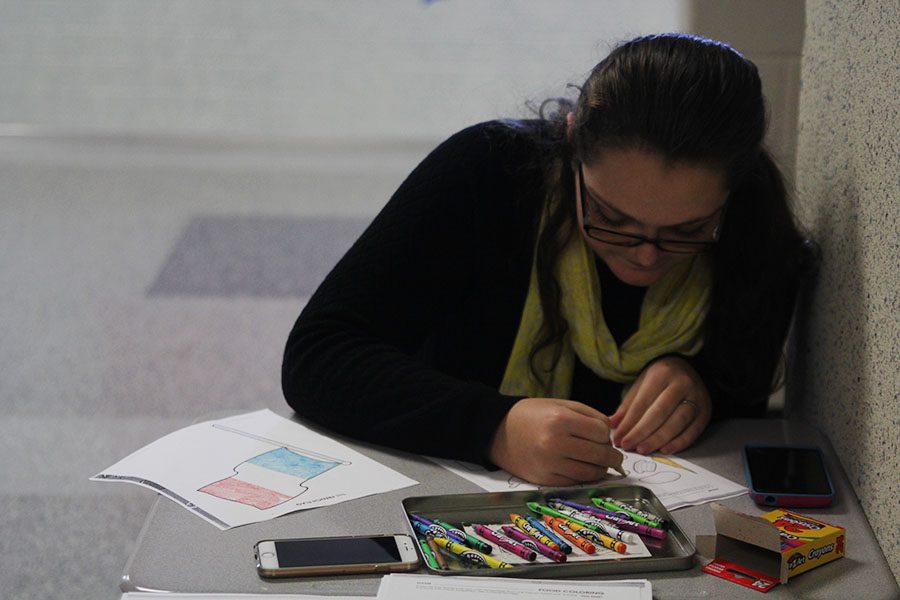 Sophomore Makayla King colors on a worksheet in honor of National French Week on Wednesday, Nov. 9. "I'm not in French class, but I got to learn about the colors and the different types of food," King said. "I thought it was fun and a good interactive way to learn more about the French culture."