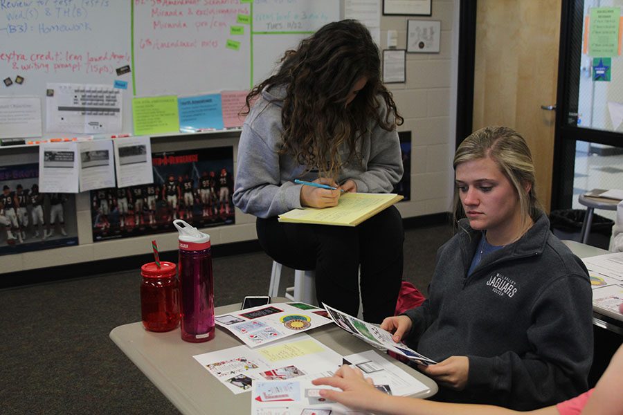 Senior Sidney Lawyer looks at ticket choices for prom during the prom committee meeting. 