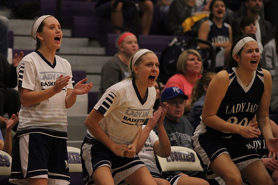 After scoring, junior Delaney Spoonmore and sophomores Lexi Ballard and Trinity Knapp cheer.