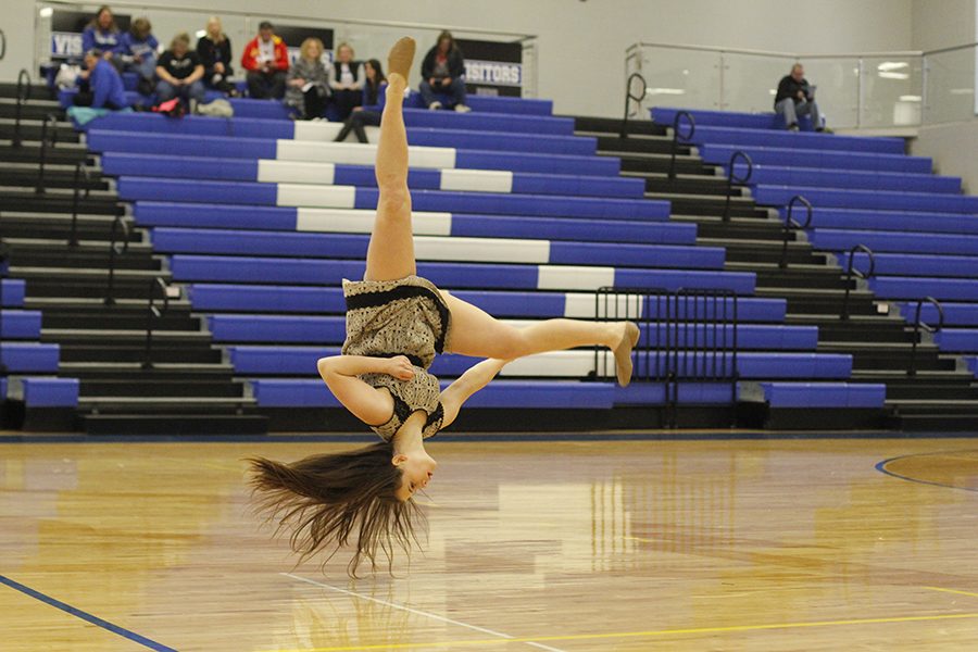 Sophomore Olivia Augustine flips during her solo.