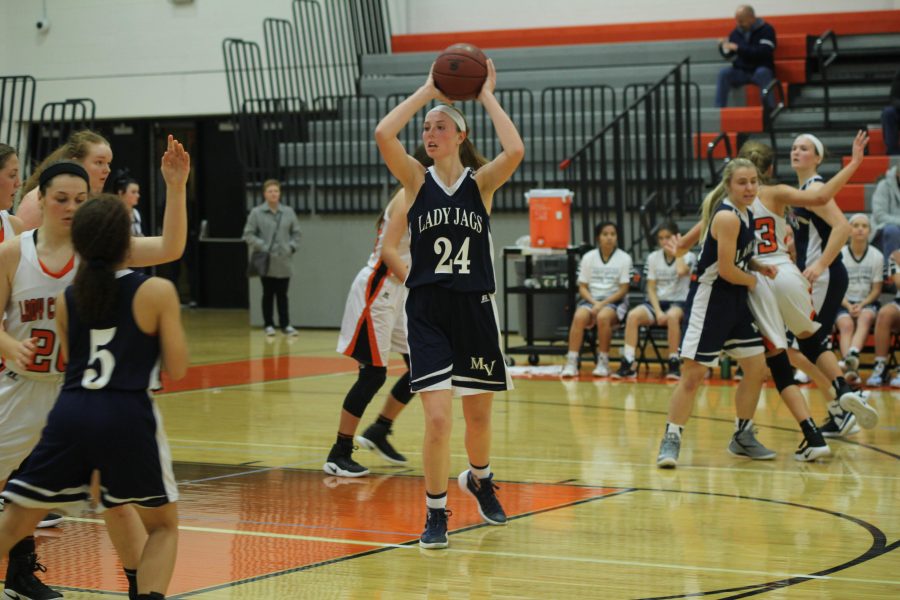 Looking for a place to pass, junior Evan Zars hesitates to throw the ball.