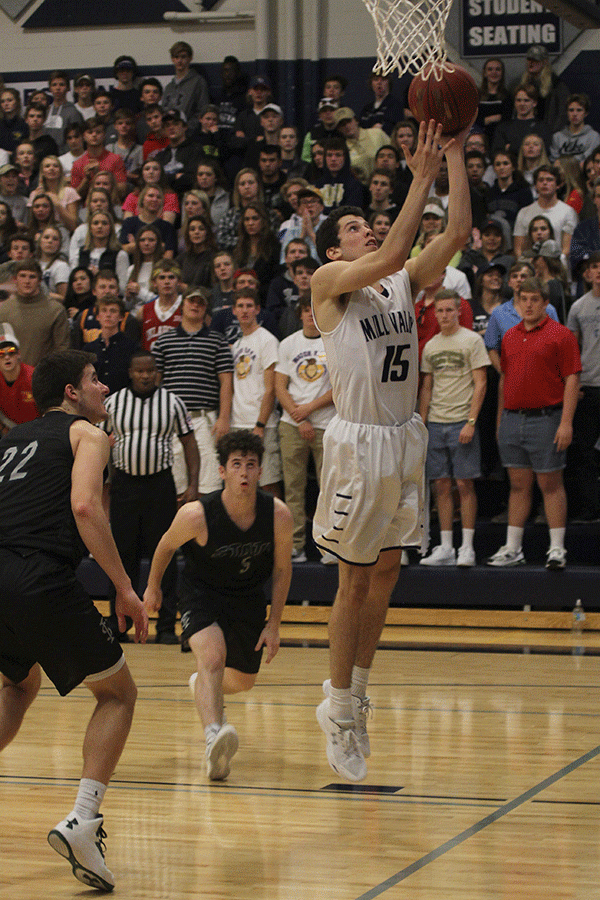 After seeing an opening, junior Mason Little goes for a basket.