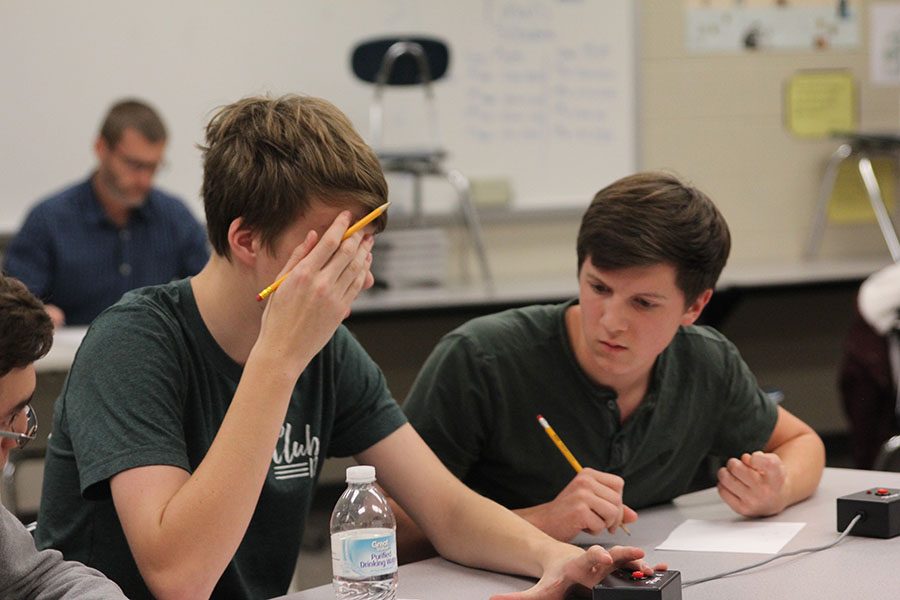Juniors Jarod Griggs and Sam Phipps work out the answer of the math problem at the Turner tournament on Thursday, Dec. 8.