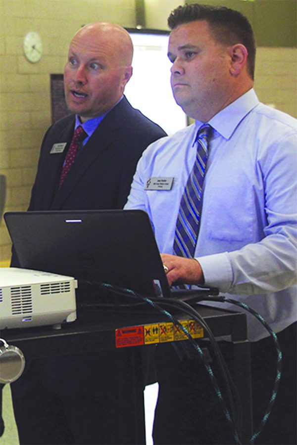 Mill Creek principal Josh Kindler helps director of secondary personal Brian Schwanz with a presentation at the community engagement meeting on Thursday, Oct. 6.