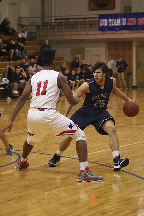 While dribbling the ball, junior Ike Valencia takes on an opponent.