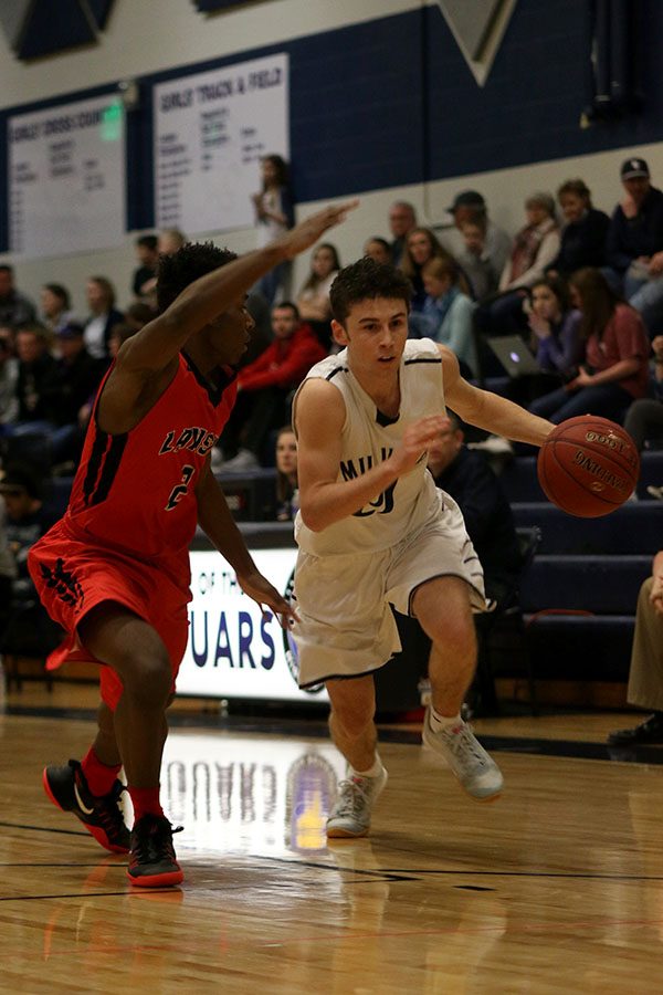 Senior Blake Montgomery dodges his opponent while dribbling the ball.