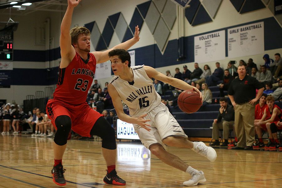 Junior Mason Little dribbles down the court towards the basket.