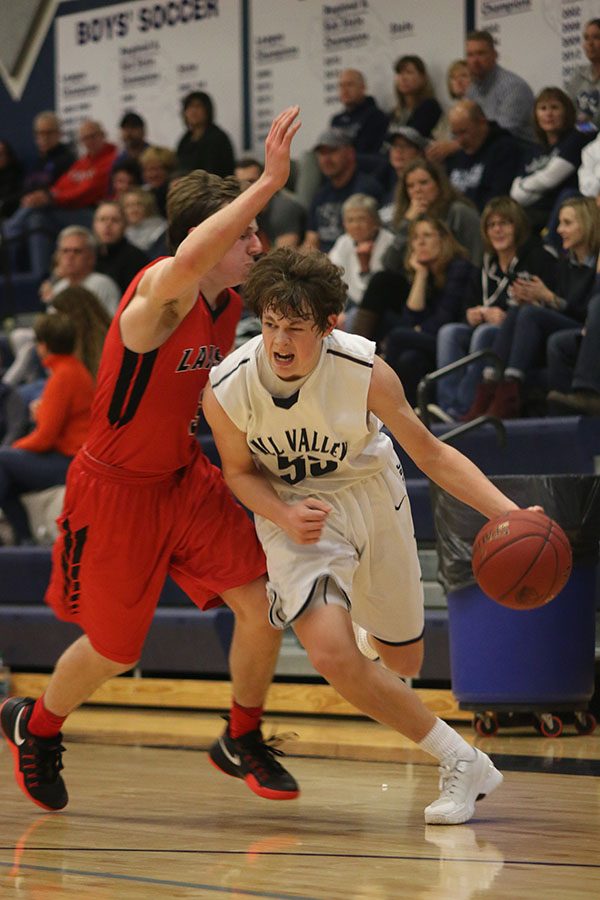 Sophomore Tanner Moore dribbles past his opponent.