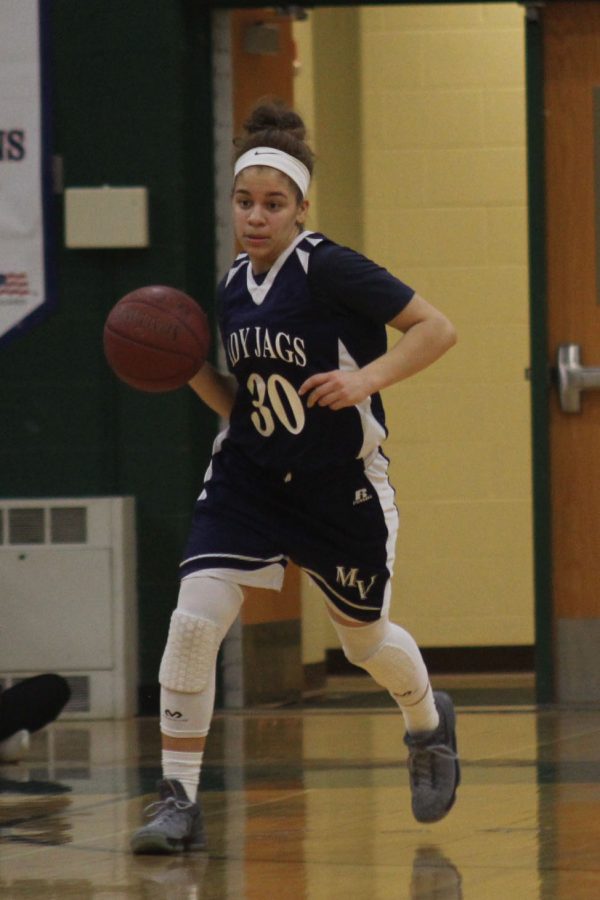 Senior Elena Artis dribbles the ball down the court.