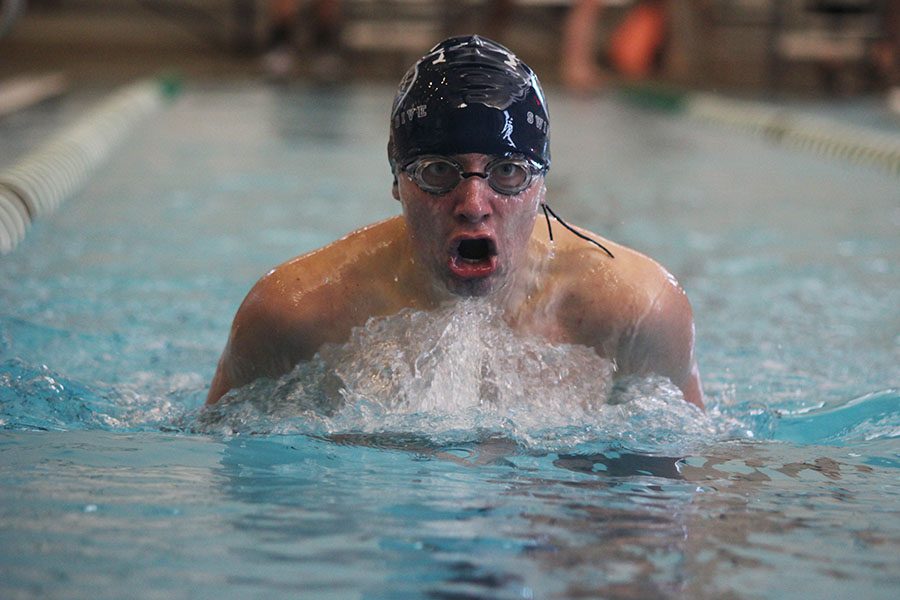 While swimming the breaststroke, sophomore Jakob Twigg keeps his eyes on the end of his lane. 