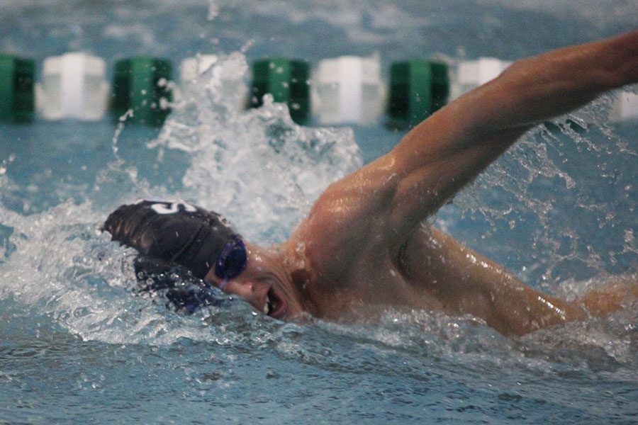 During the freestyle, senior Travis Collins uses his arm to progress further down the lane. 