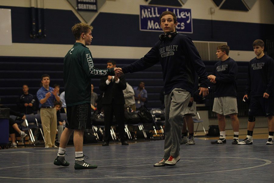 Senior Dylan Gowin shakes his opponents hand at the beginning of the meet. 