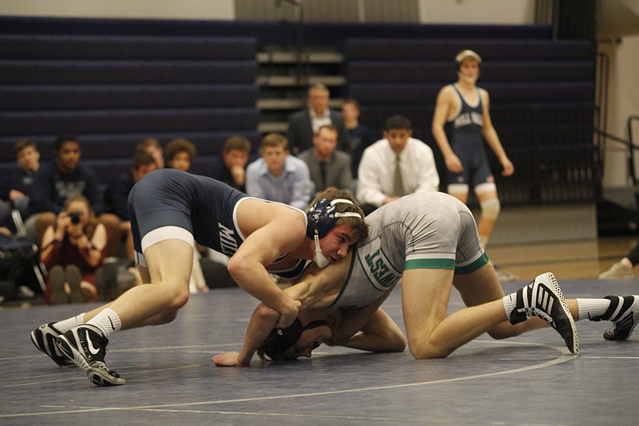During his match junior Conner Ward tries to take down his opponent. 