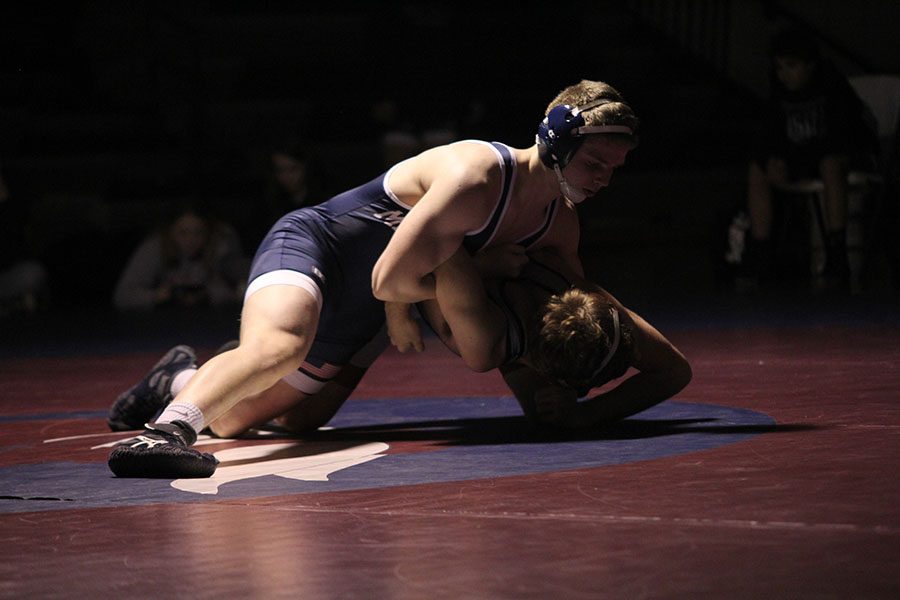 Senior Jett Bendure takes down his Seaman high school opponent. 