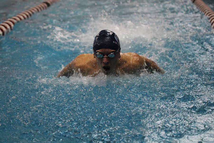 In the 200 yard medley relay, junior Carter Lawson performs the butterfly on Thursday, Jan. 26.