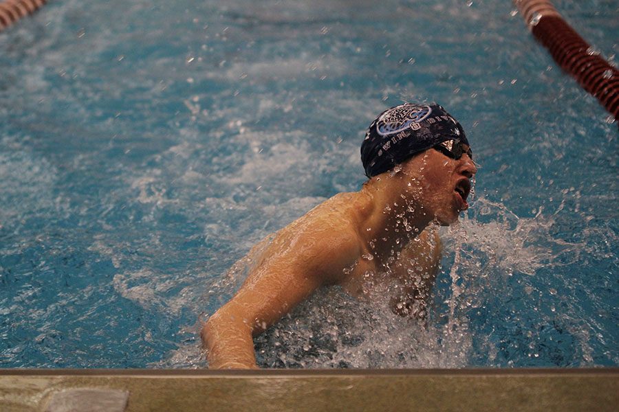 Breathing for air, sophomore Chris Sprenger turns back to complete his individual medley.