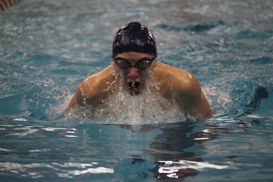 Sophomore Jakob Twigg takes a breath in the 100 yard breaststroke.