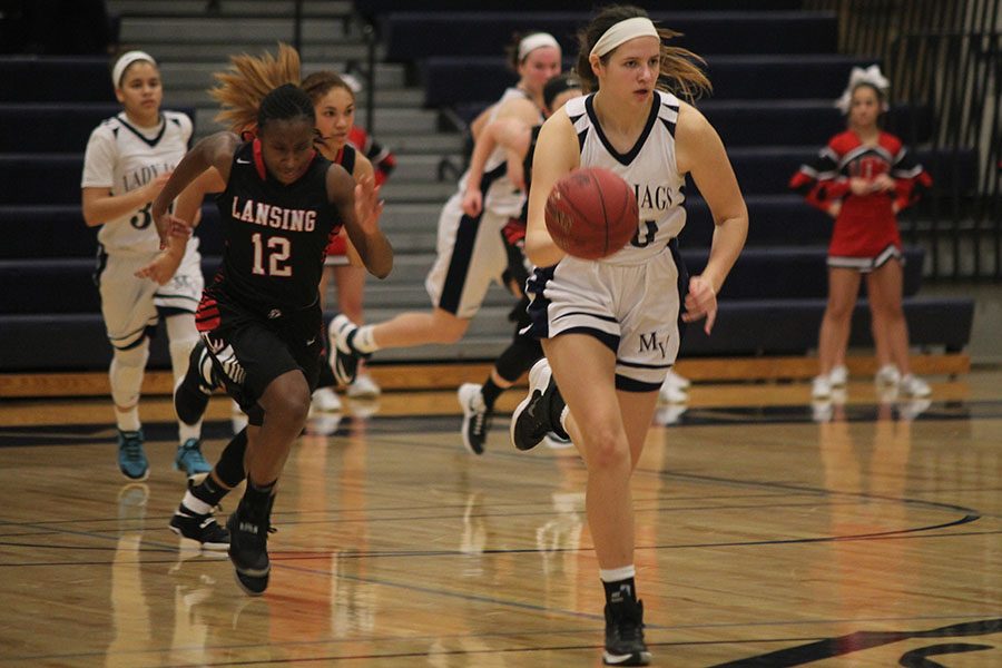 Dribbling down the court, sophomore Trinity Knapp advances the ball toward the goal.