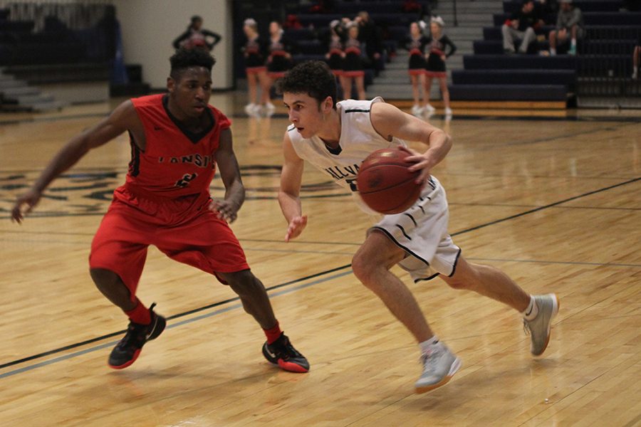 Senior Blake Montgomery looks past a Lansing defender for an opening.