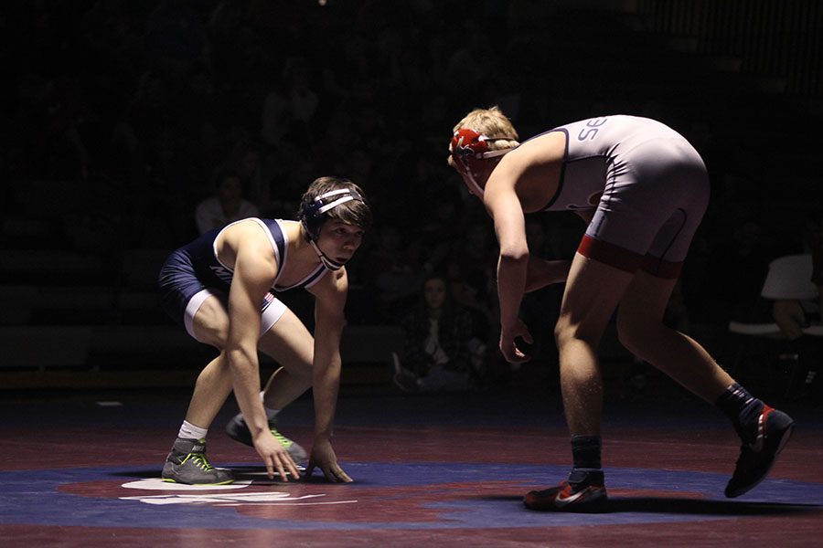 Junior Bryson Markovich prepares to advance towards his opponent. The Jaguars beat Topeka Seaman 43-30 and were defeated by Shawnee Heights with a score of 33-43 on Wednesday, Jan. 18 at Topeka Seamen. 