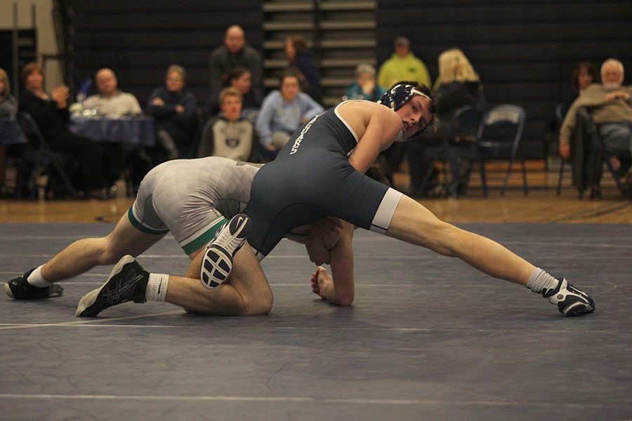 Senior Joey Gray looks over his shoulder at the coaches to know what he should do next during his match.