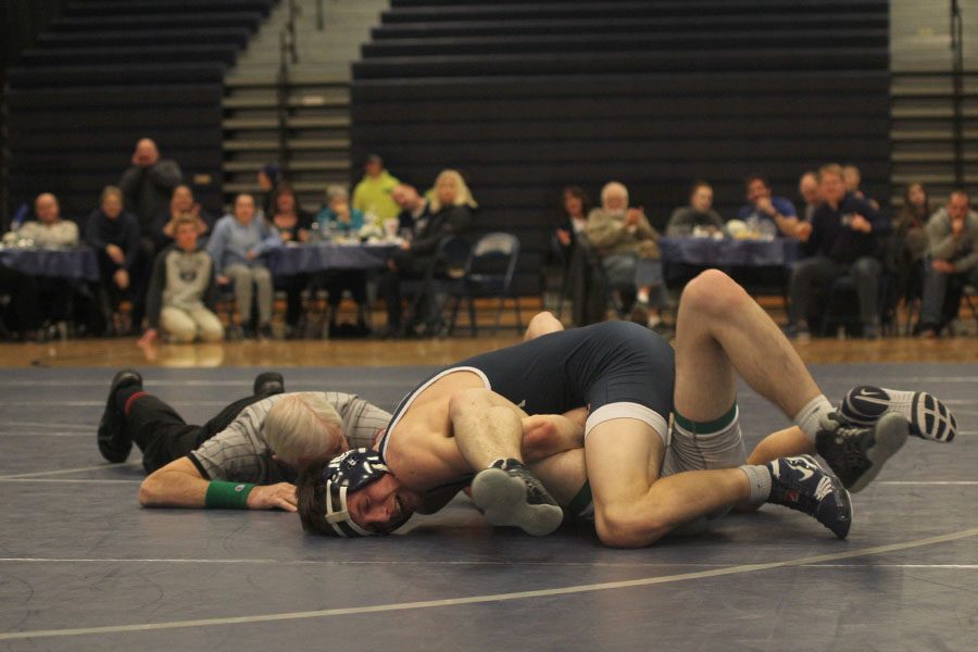 Senior Joey Gray pins his opponent to end the match.