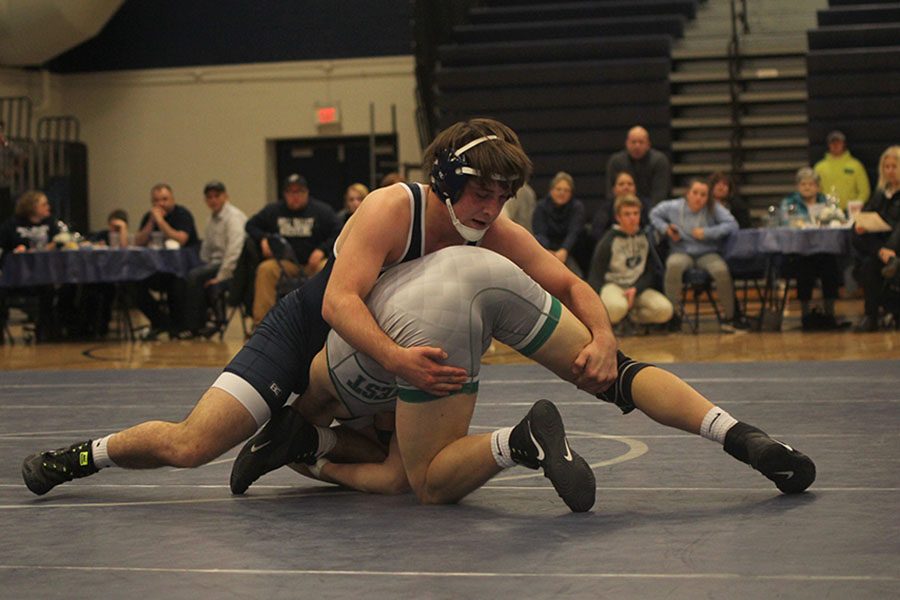 Junior Hayden Keopke sprawls on his opponent to keep him from getting points.
