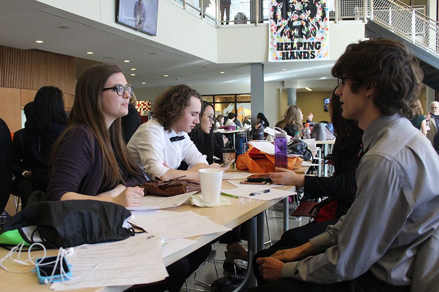 Along with senior Sydney Williamson, juniors Parker Johnson (middle) and Zoltan Gothard (right) prepare their competition pieces in the Lansing High School commons on Saturday, Jan. 28.