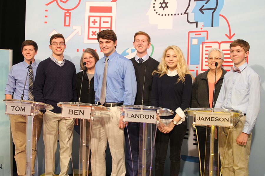 Posing for pictures, the Quiz Bowl team stands tall. From left to right: junior Sam Phipps, senior Tom McClain, coach Mary Beth Mattingly, senior Ben Stadler, junior Landon Butler, senior Emma Wilhoit, coach Donna Riss and junior Jameson Isaacsen.
