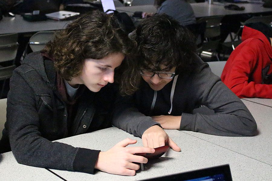 After watching the live stream kickoff video on Saturday, Jan. 7, juniors Cody Robertson and Andres Rico research the parameters that the Jaguar Robotics team must follow while constructing their robot.  