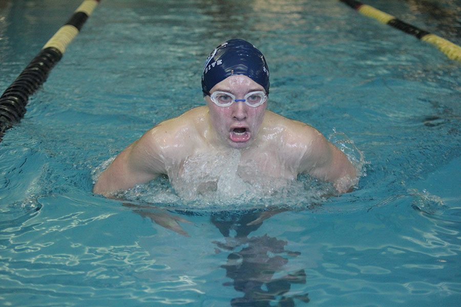 As he reaches the end of his lane, sophomore Jakob Twigg breaststrokes to the finish  on Monday, Jan. 9.