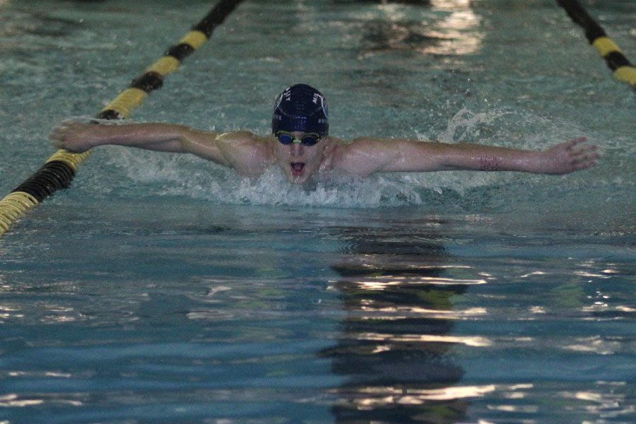 As he comes up for a breath, freshman Colby Beggs completes the butterfly on Monday, Jan. 9.